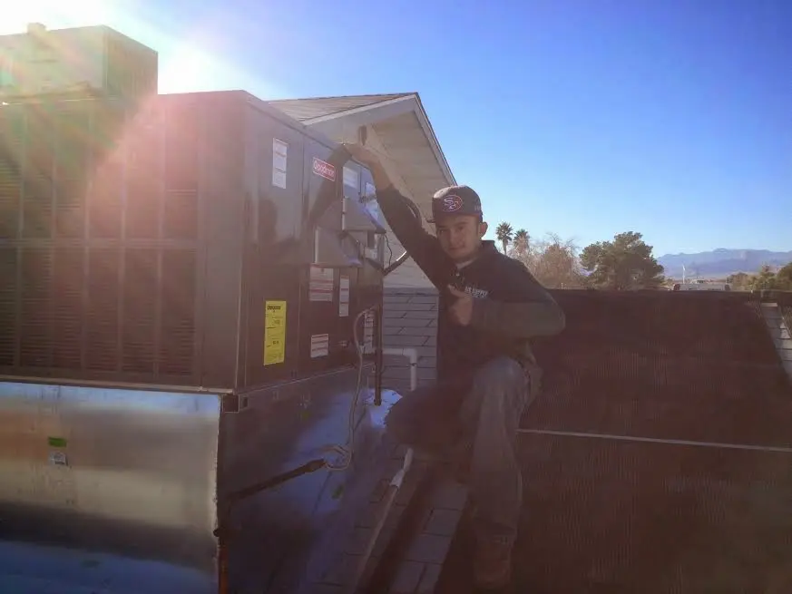HVAC technician performing HVAC Inspection on a rooftop unit in West Earl